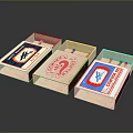 Three Vintage Matchboxes With Colorful Labels And Distinct Designs On Reflective Surface