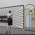 Contemporary Art Installation With Radial Lines Central Text Arched Frames Green Plants And Standing Woman