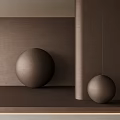 Polished Metallic Sphere Sculptures Displayed Against Brown Textured Wall Background