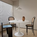 Minimalist Dining Table Set With White Round Table Rattan And Black Chairs Pendant Light