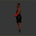 Shirtless Male Boxer Posing In Red Gloves And Black Shorts On Gray Background