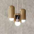 Wooden Pendant Lights Three Cylindrical Design With White Light Gray Wall Background
