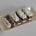 Delicious Layered Chocolate Cake With Cream And Jam Topping On Beige Tray