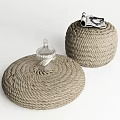 Round Woven Rope Stools in Gray with Small Glass Bottle and Rolled Magazine