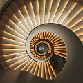 Modern Spiral Staircase Featuring Wooden Steps And Soft Lighting With Person At Bottom