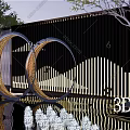 Modern Metal Circular Sculpture With Illuminated Design And Outdoor Screen Backdrop