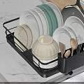 Black Kitchen Dish Rack With Plates Bowls Spoons Near Sink On Marble Countertop