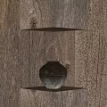 Ceramic Jar with Textured Surface on Wooden Shelves Against Natural Wood Background