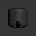 Modern Cylindrical Computer Speaker With Textured Fabric Body And Dark Green Top Surface