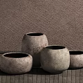 Natural Textured Ceramic Vessels In Various Sizes With Woven Wall And Wooden Floor