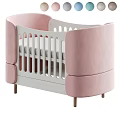Modern Baby Crib With Pink Padded Sides White Railings And Wooden Legs
