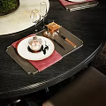 Elegant Dinnerware Set With Red Napkins White Plates And Metal Cutlery On Black Dining Table