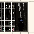 Modern Decorative Cabinet With Grid Shelf Design Displaying Colorful Toy Figures And Accent Figure