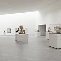 Bright Spacious Art Gallery With White Pedestals Sculptures And Wall Paintings
