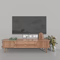 Wooden TV Stand with TV on Top Featuring Drawers Cabinet Doors Books and Potted Plants