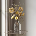 Clear Glass Vase With Yellow And Beige Dried Flowers On Metal Table