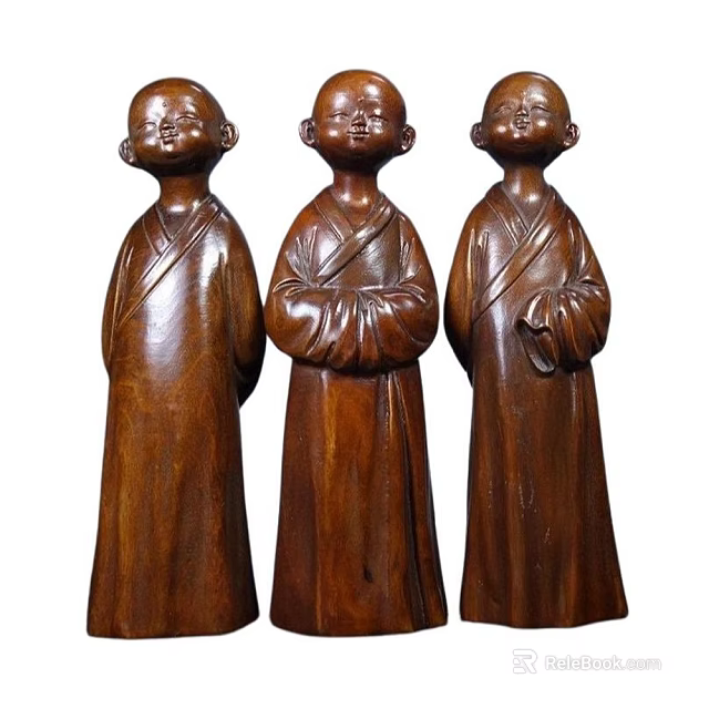 Three Hand Carved Wooden Monk Sculptures With Traditional Robes And Standing Postures 3d model 