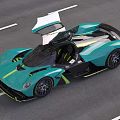 Turquoise Supercar with Sleek Aerodynamic Design and Yellow Accents Cruising on Highway