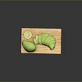 Fresh Avocado Whole and Sliced with Lime on Wooden Cutting Board
