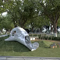 White Dolphin Head Garden Sculpture on Green Lawn with Trees and Barrel Decorations