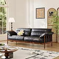 Black Leather Three Seater Sofa With Wooden Legs And Accent Pillow In Sunlit Living Room