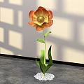 Elegant Floral Display with Orange Yellow Flower Green Leaves and White Pebble Base