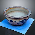 Carved Ceramic Basin With Blue And White Patterns On Blue Paper Background 3d model