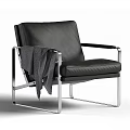 Black Leather Accent Chair with Sleek Metal Frame and Gray Blanket on Seat