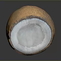 Halved Coconut With White Flesh And Brown Outer Shell On Dark Surface