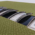 Modern Landscape Bridge with Multiple Arched Design Over Reflecting Water in Green Grassy Area