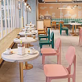 Dessert Shop Interior Design With Green Banquette Colorful Chairs And White Marble Tables