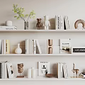 Decorative Ornament Set On White Shelves With Books Sculptures Vases And Green Plant