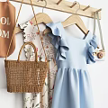 Stylish Clothing Hanger With Blue Ruffled Dress Woven Handbag And Camera Accessory