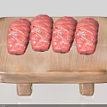 Four Pieces of Raw Rolled Meat on Wooden Cutting Board Ready to Cook