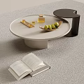 Modern Round Light Colored Coffee Table With Open Book Plate Of Green Fruits