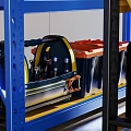 Organized Workshop Tool Storage With Yellow Toolboxes Blue Shelving And Safety Vest