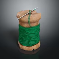 Wooden Spool Wound With Green Thread And Needle Against Dark Background