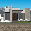 Modern Detached Home Exterior With White Stone Accent Walls Large Windows Wooden Door Gravel Driveway