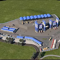 Industrial Factory Aerial View With Green Forest Surroundings Blue Roof Structures Roadways And Vehicles