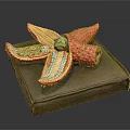 Colorful Decorative Starfish Ornament With Red Yellow Green Petals On Brown Box