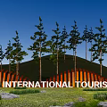Orange Curved Feature Wall at International Tourist Resort with Trees Grassland Stones and Blue Sky