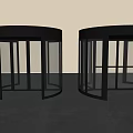 Two Modern Black Revolving Doors With Glass Panels And Metal Frames