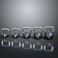 Five Shiny Metal Kettlebells With Reflective Surfaces On Gray Background