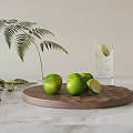 Fresh Limes On Wooden Tray Over Marble Surface With Greenery And Water Glass