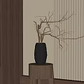 Textured Black Vase With Dried Branches On Wooden Stool Against Vertical Striped Wall