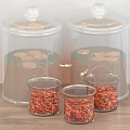 Clear Glass Spice Jars with Lids and Small Containers on Wooden Countertop