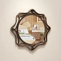 Ornate Round Wall Mirror with Decorative Bronze Frame Reflecting Bedroom Bed and Nightstand