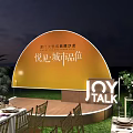 Elegant Outdoor Night Banquet Setup With Long Tables Green Lawn And Yellow Backdrop