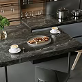 Modern Kitchen Interior With Wooden And Black Cabinets Gray Island And Green Plants