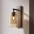 Modern Wall Sconce With Amber Glass Shade And Dark Metal Base On Light Wall